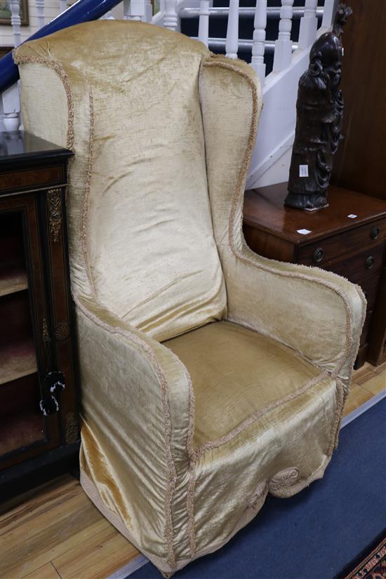 A silk damask wingback armchair